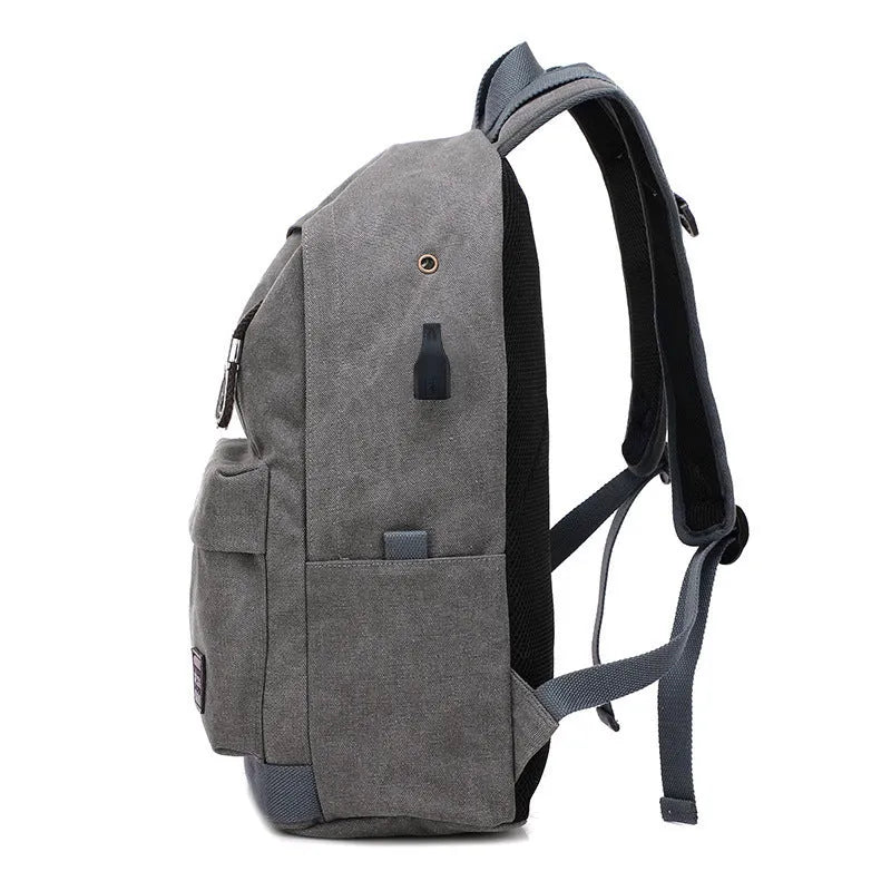 Canvas backpack with USB charging port and multiple pockets including a laptop compartment