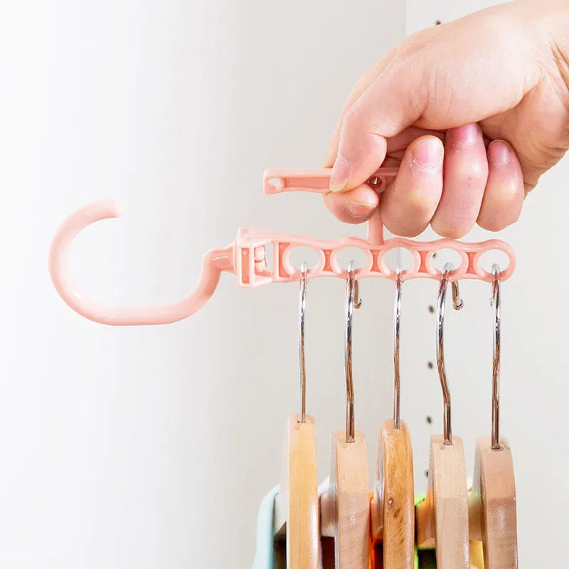 Blue revolving wardrobe hanger with five rotating branches and handle for space saving