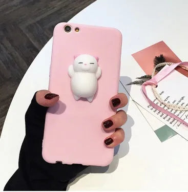 Soft pink silicone iPhone case with a raised 3D cartoon cat design on the back.