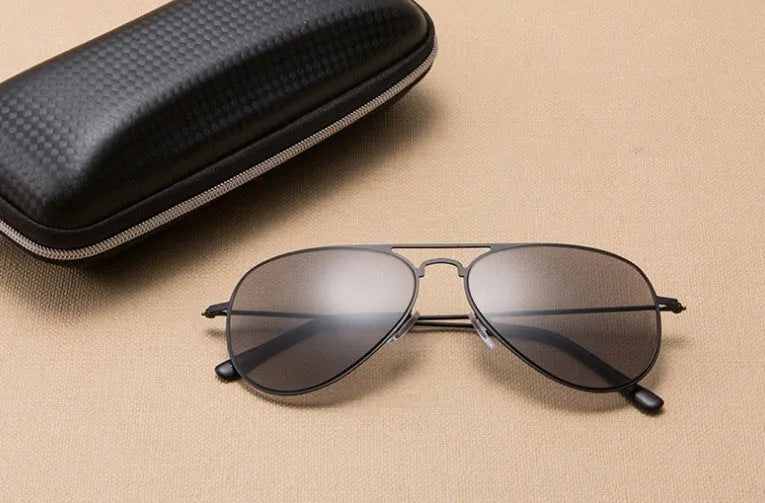 Full lens sun reading glasses with black stainless steel frame resting on a table