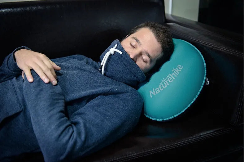 Travel portable inflatable pillow in bright orange with air mouth for camping outdoor sports