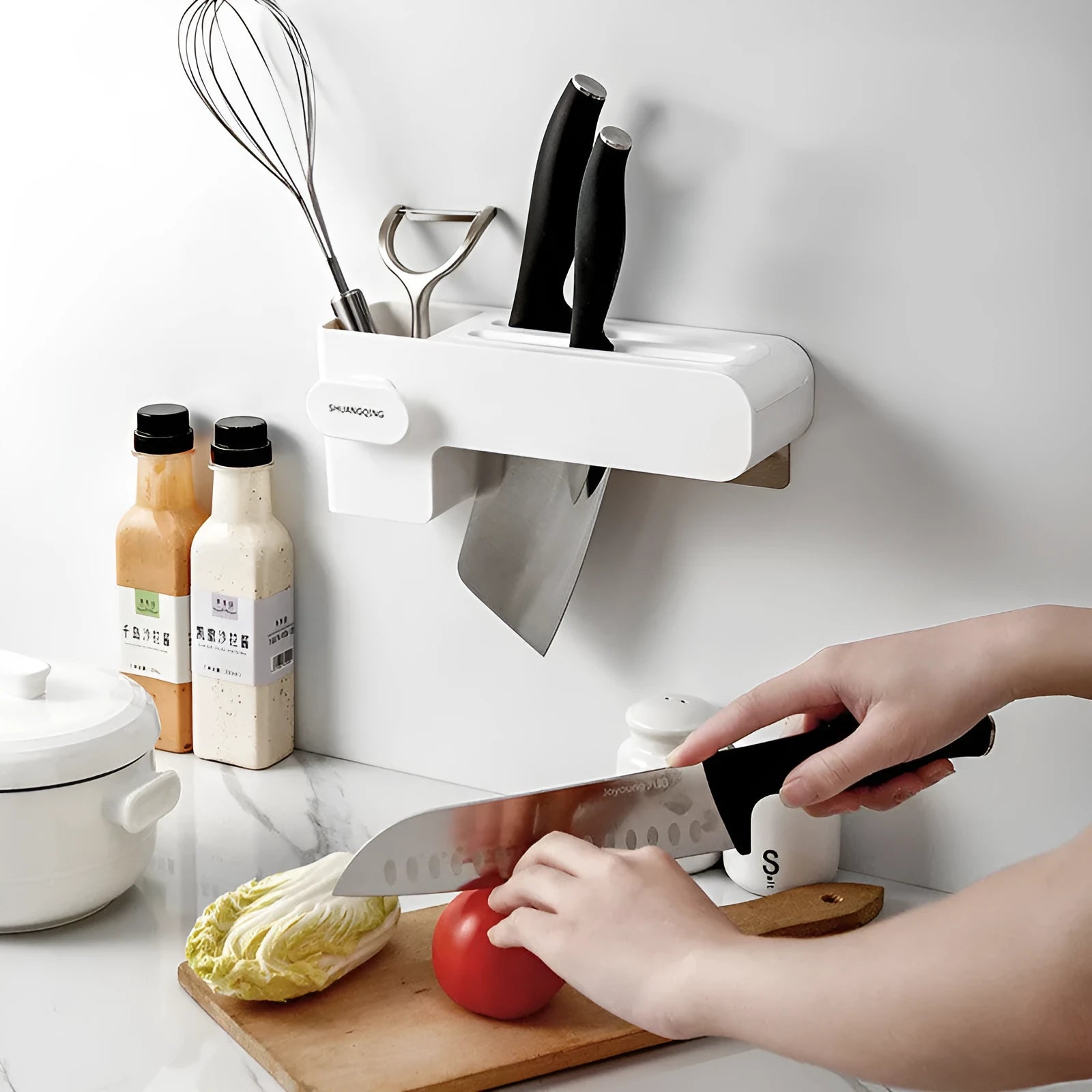 White plastic kitchen knife rack with modern simple design on countertop holding several knives