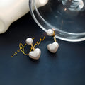 Korean style heart-shaped alloy stud earrings for women with artificial gem inlay on a white background.