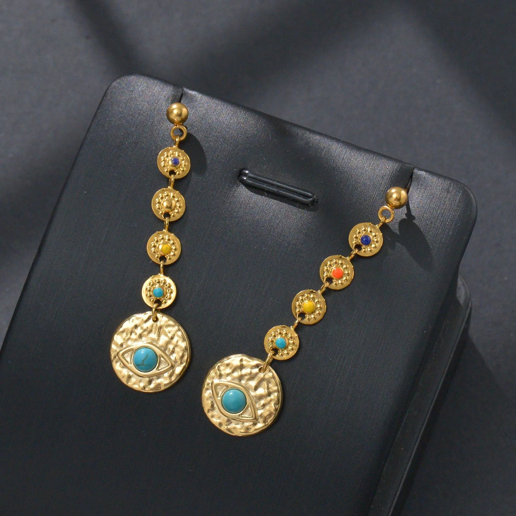 Stainless steel geometric drop earrings in Eight Awn Star, Eye, and Shell Sun designs.