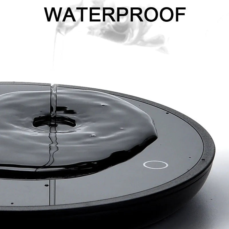 Black circular cup warmer with temperature control buttons on side