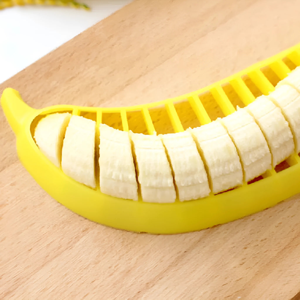 Yellow banana cutter slicer made from food-grade PP plastic, 25 x 7 x 1.4 cm, on a light background