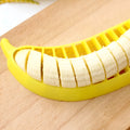 Yellow banana cutter slicer made from food-grade PP plastic, 25 x 7 x 1.4 cm, on a light background