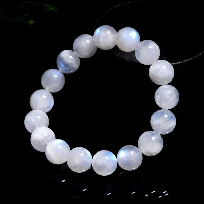 Natural blue moonlight round bead moonstone bracelet showing polished gemstone beads on wrist