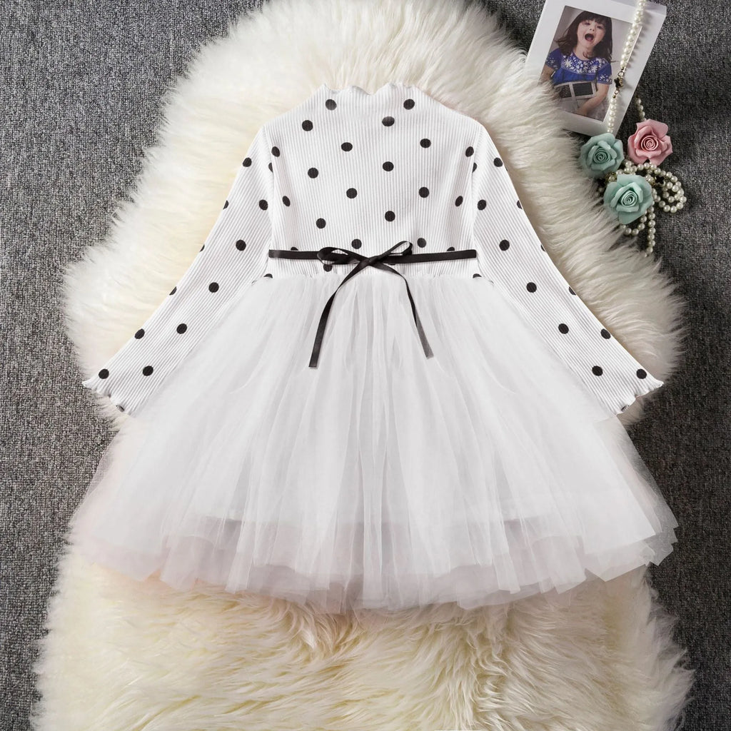 A baby girl's long sleeve black tutu dress with lace detail, suitable for birthdays and christenings.