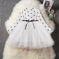 A baby girl's long sleeve black tutu dress with lace detail, suitable for birthdays and christenings.