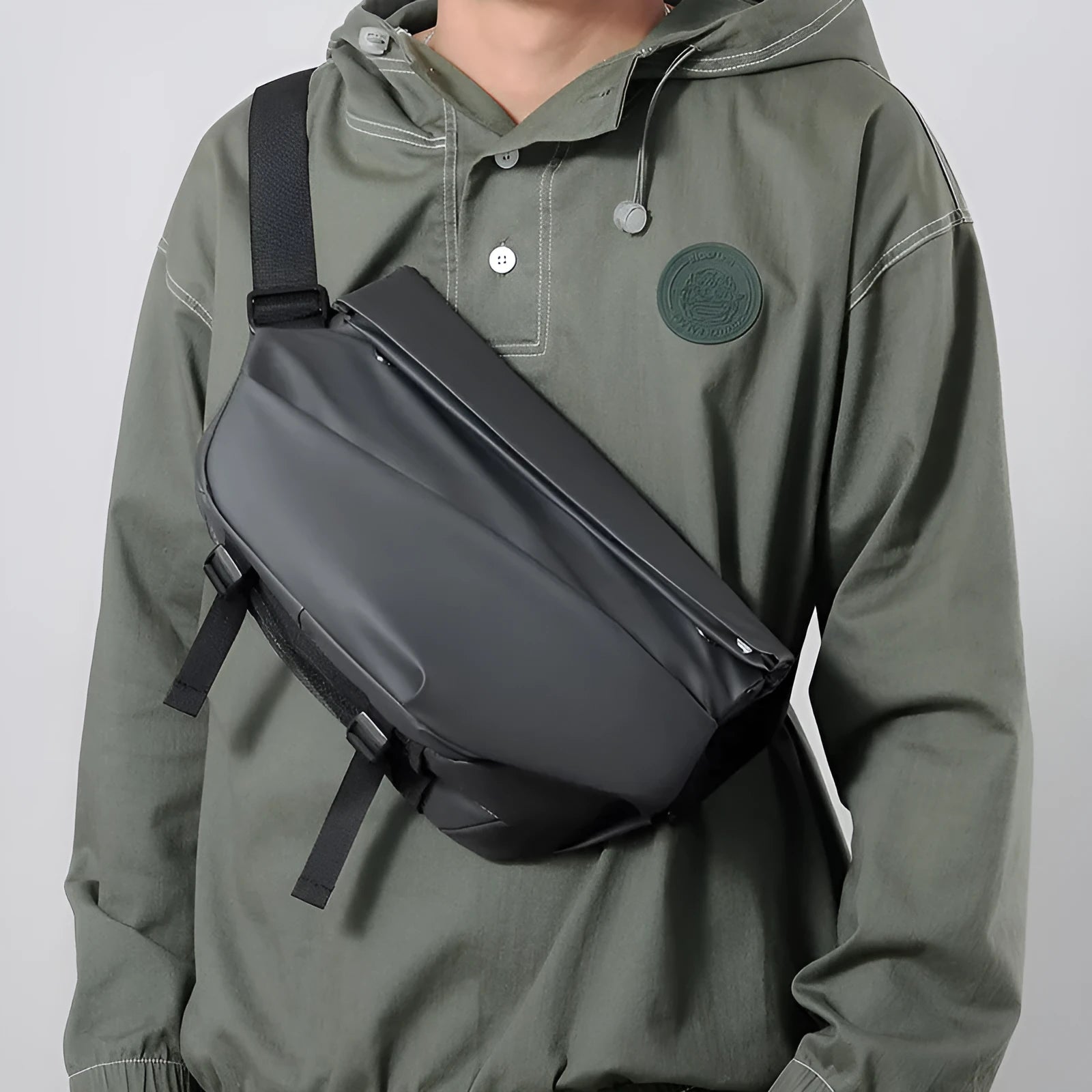 Grey men's crossbody sling backpack with zipper opening and shoulder strap