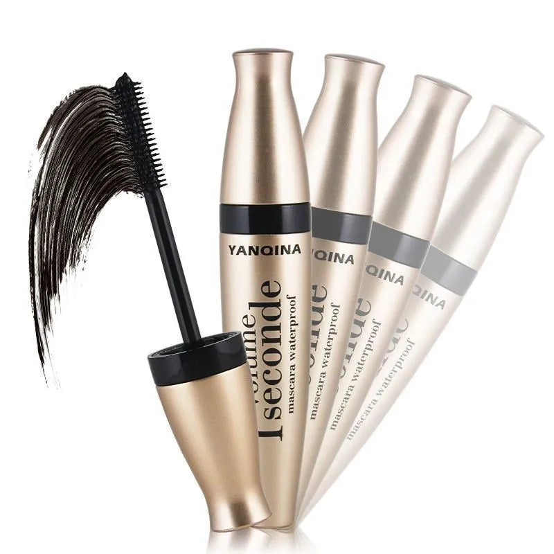 Gold tube black mascara in a vertical orientation against a light background