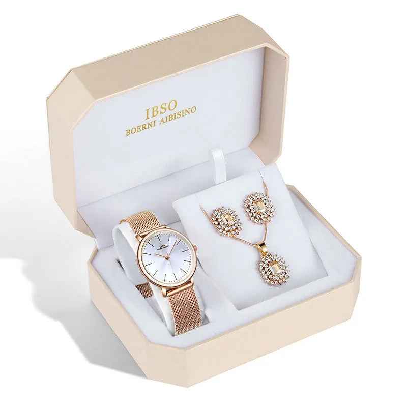 Women's quartz watch and jewellery set with 30mm dial, silver case, and stainless steel buckle, on a white background