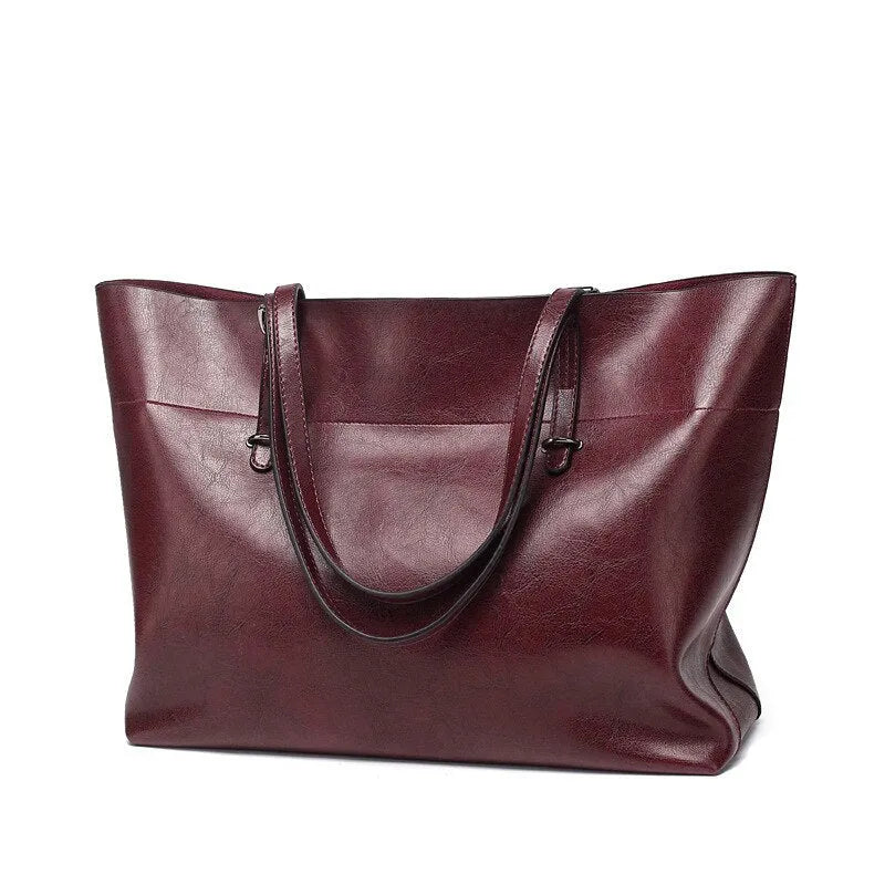 Horizontal leather crossbody handbag in waxed cowhide with two main compartments and a phone pouch.