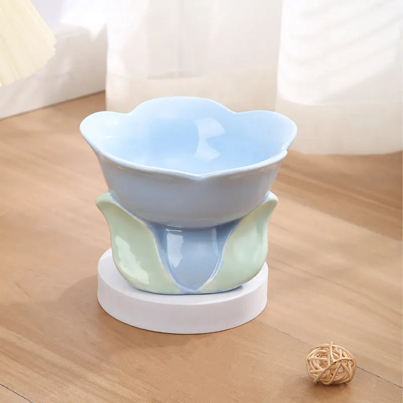 Blue ceramic raised pet bowl with floral pattern and non-slip base for cats and small dogs.