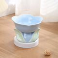 Blue ceramic raised pet bowl with floral pattern and non-slip base for cats and small dogs.