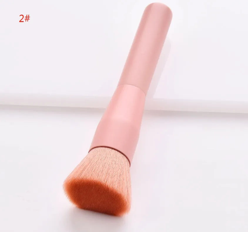 Ten cosmetic makeup brushes with wooden handles arranged showing various brush head shapes and sizes