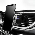 Black car phone holder attached to vehicle air vent with phone securely mounted