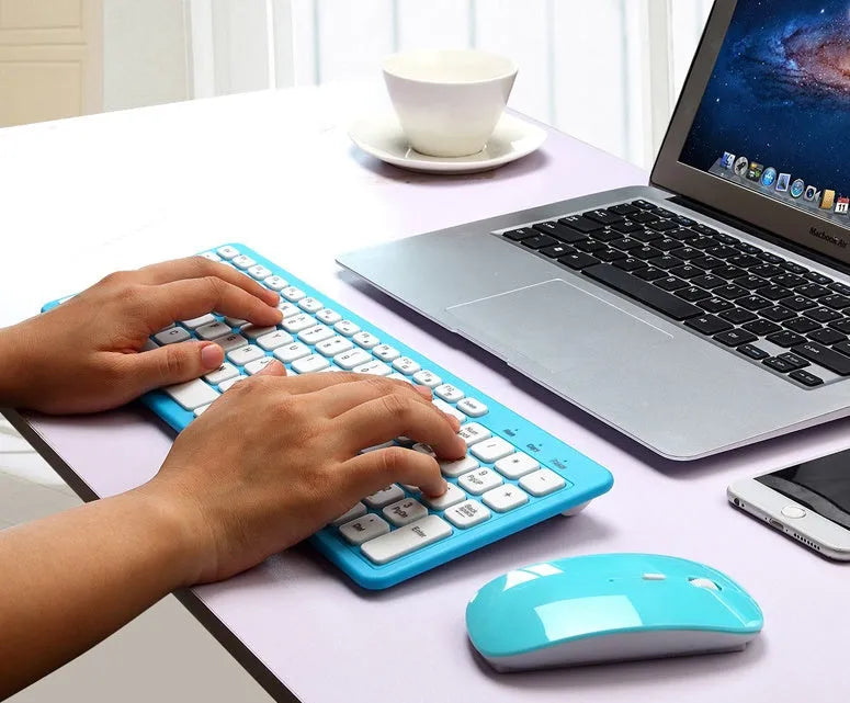 Black wireless keyboard and mouse set with USB receiver on a desk