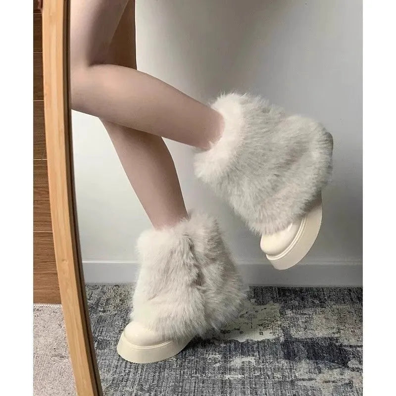 Women's black artificial plush snow boots with a low-top design and a waterproof rubber platform sole.