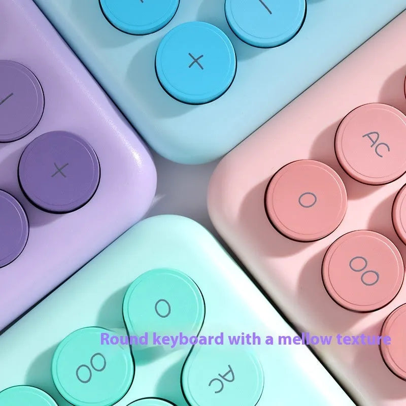 Dopamine gradient colour desktop calculator in violet, pink, blue, or green on a desk.