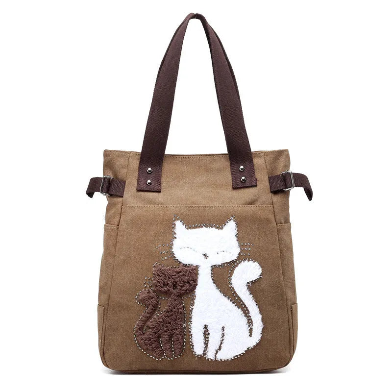 KVKY women canvas shoulder bag with cute plush cat applique in beige colour on white background