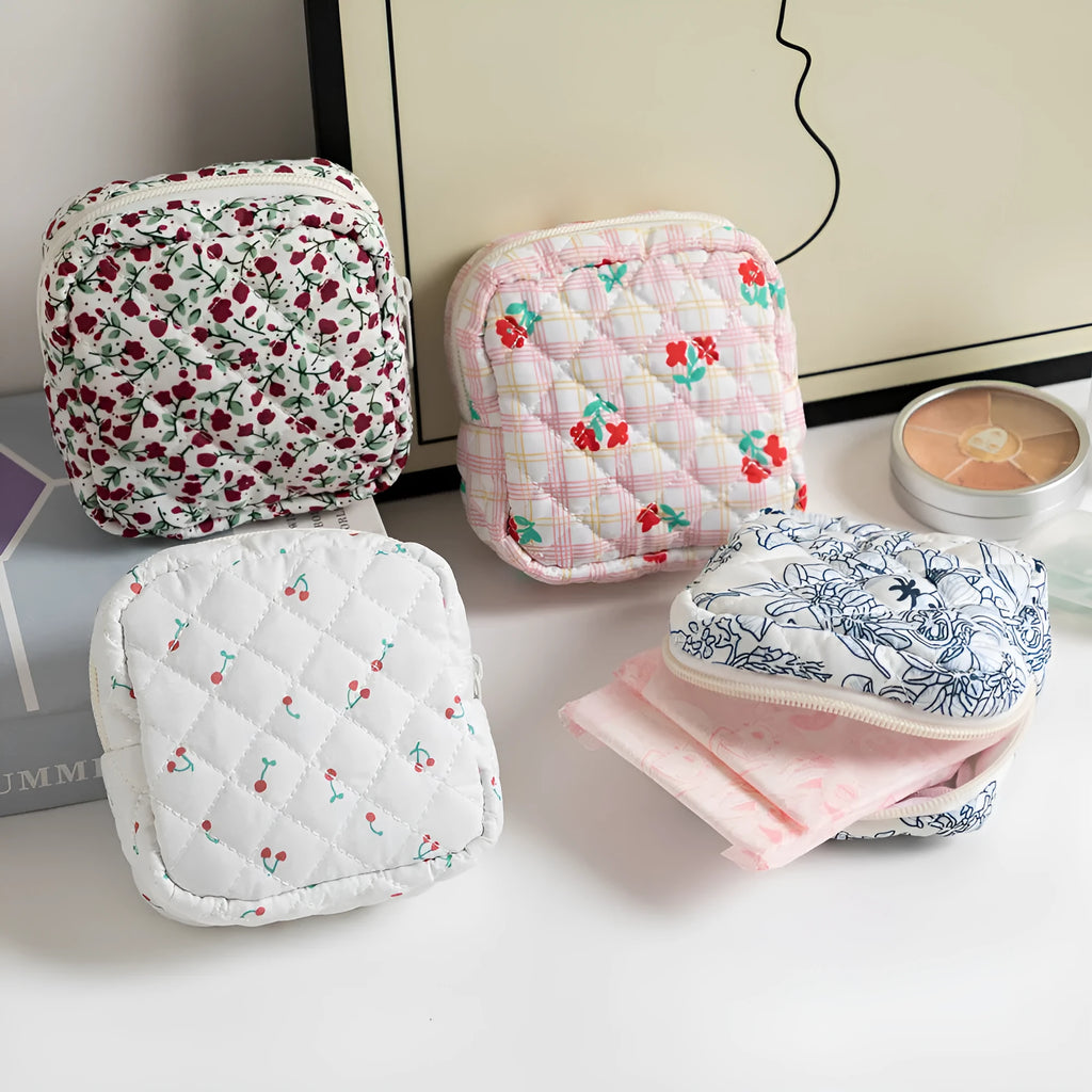 Small floral polyester key storage wallet with sewing thread detail in multiple colour patterns.