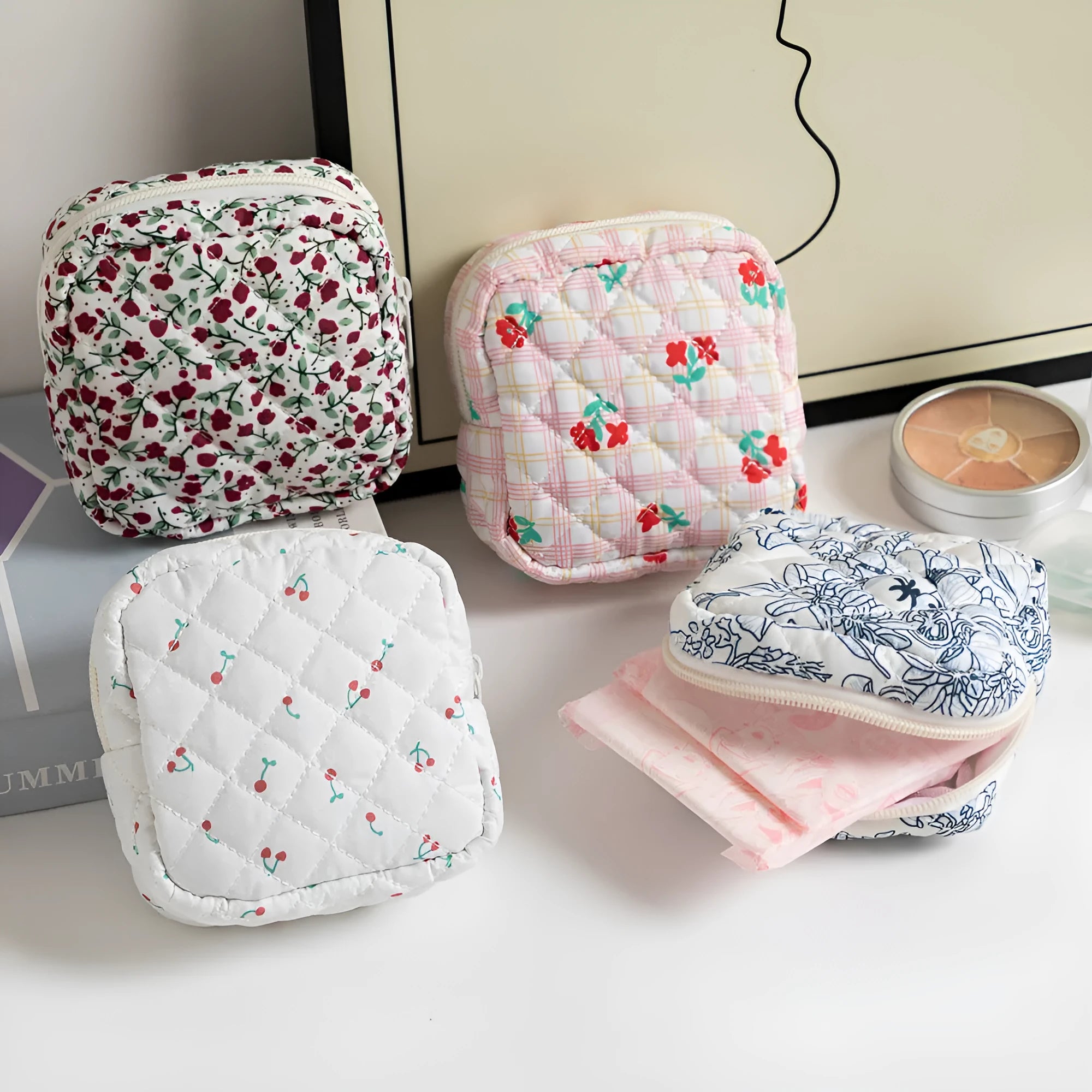 Small floral polyester key storage wallet with sewing thread detail in multiple colour patterns.