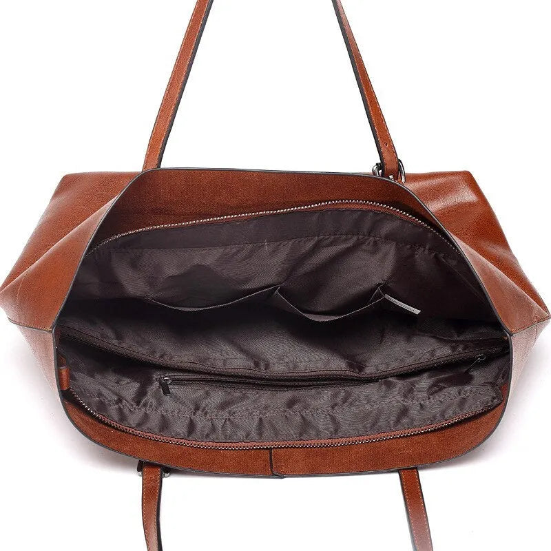 Horizontal leather crossbody handbag in waxed cowhide with two main compartments and a phone pouch.