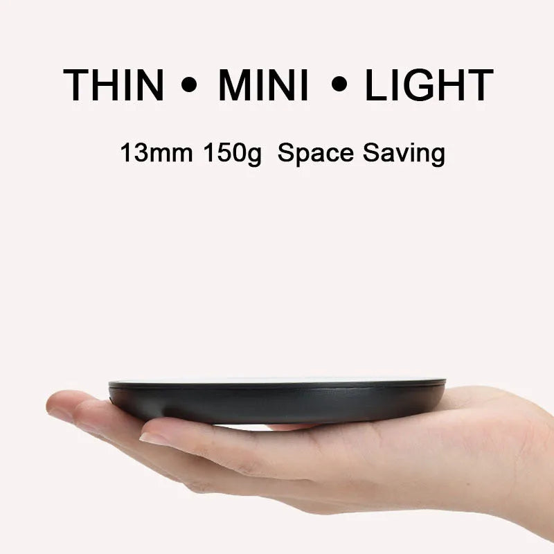 Black circular cup warmer with temperature control buttons on side