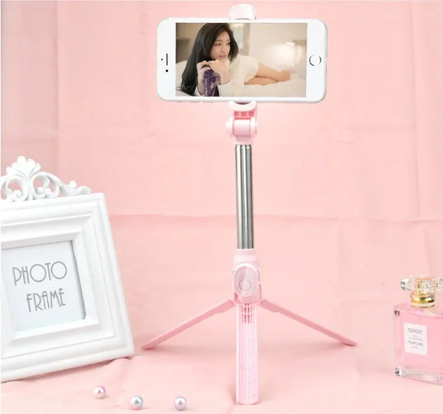 Black Bluetooth tripod selfie stand for iPhone with extended legs and rotating phone clip
