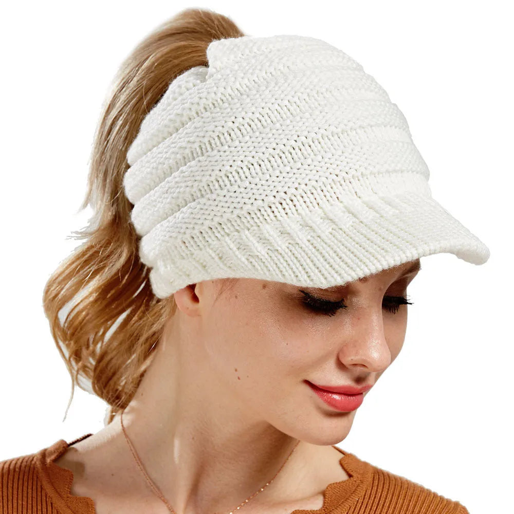 Women's grey knitted beanie with elastic opening at back for ponytail or bun hairstyle