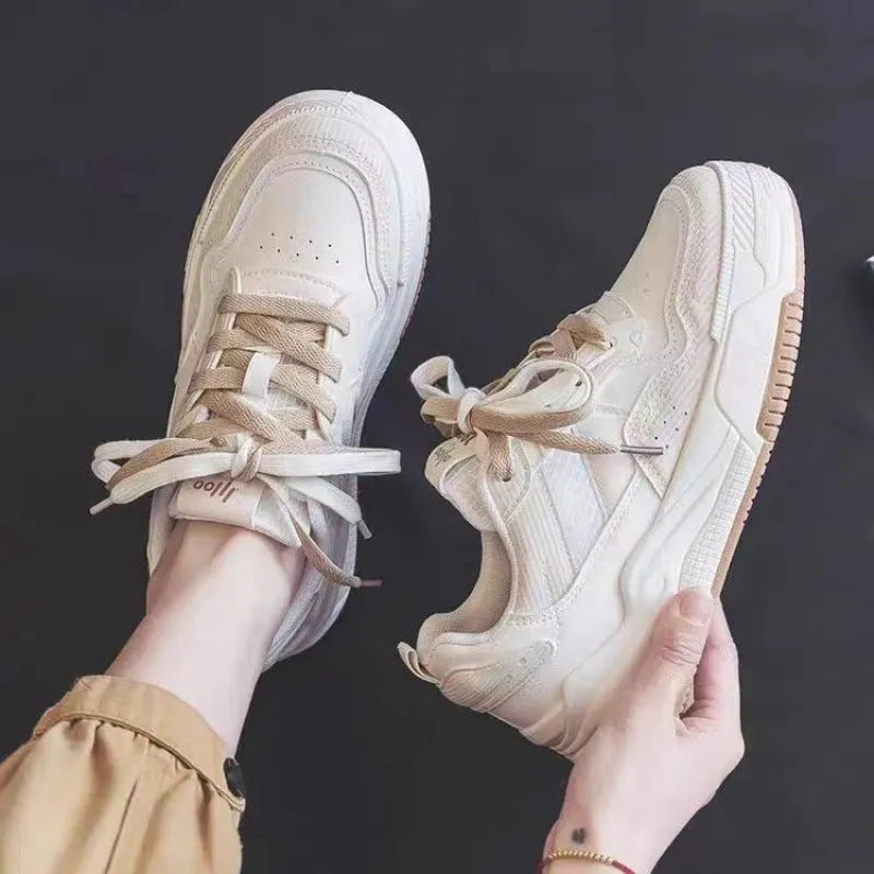 Beige and pink women's low top sneakers with a height increasing sole.