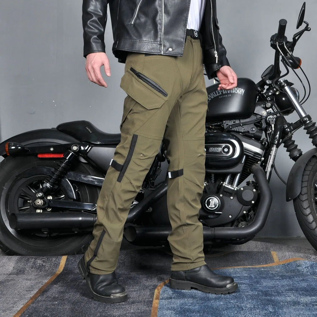 Men's green waterproof motorcycle trousers with belt and protective knee pads laid out flat.