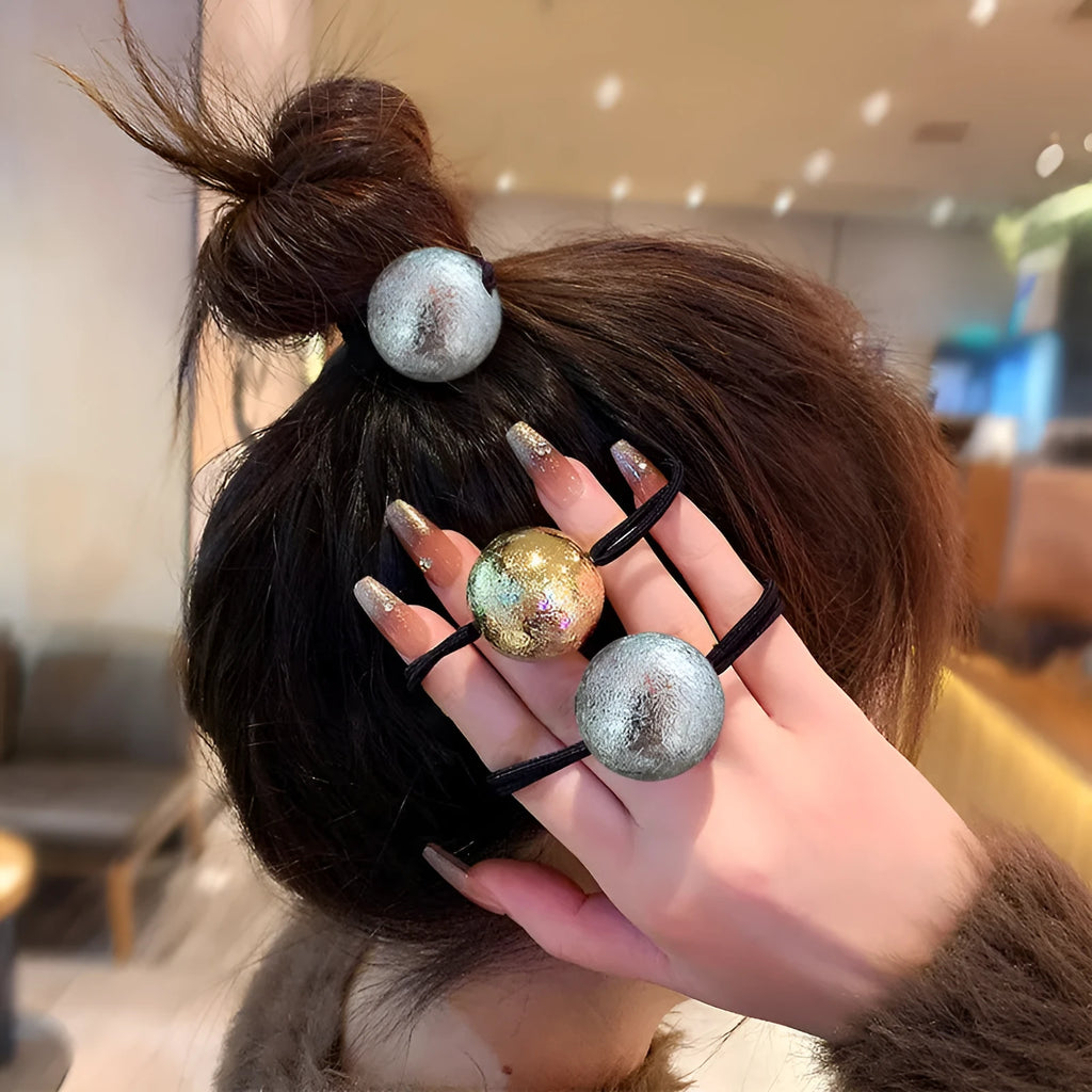 Resin hair band with electroplated gold finish, round head rope style, on a plain background
