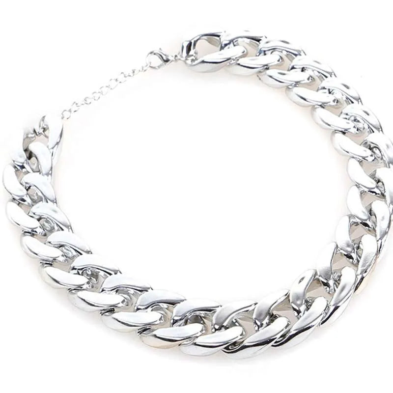 Gold chain dog collar necklace with a geometric buckle on a small dog
