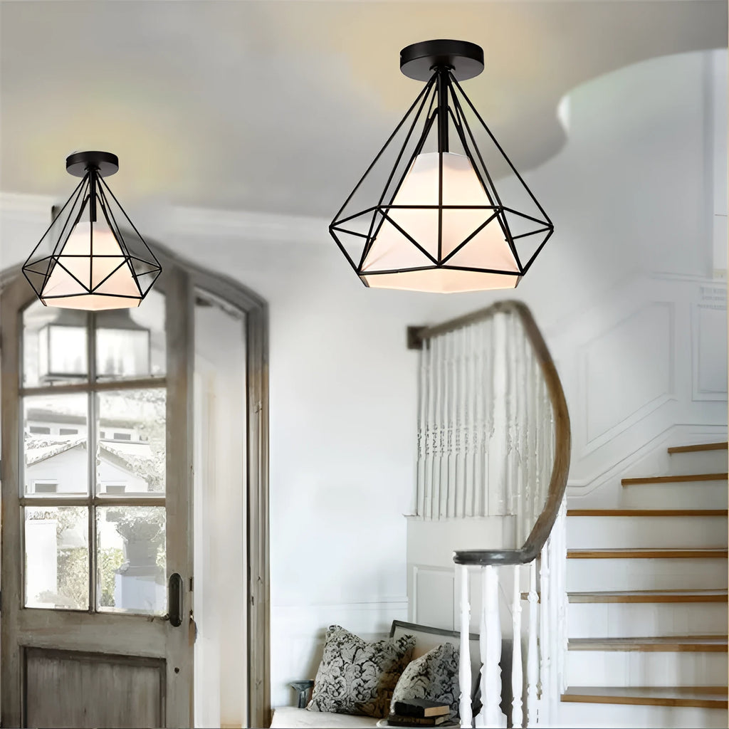 Black ceiling lamp with 10cm diameter and 1 metre adjustable drop against a white ceiling