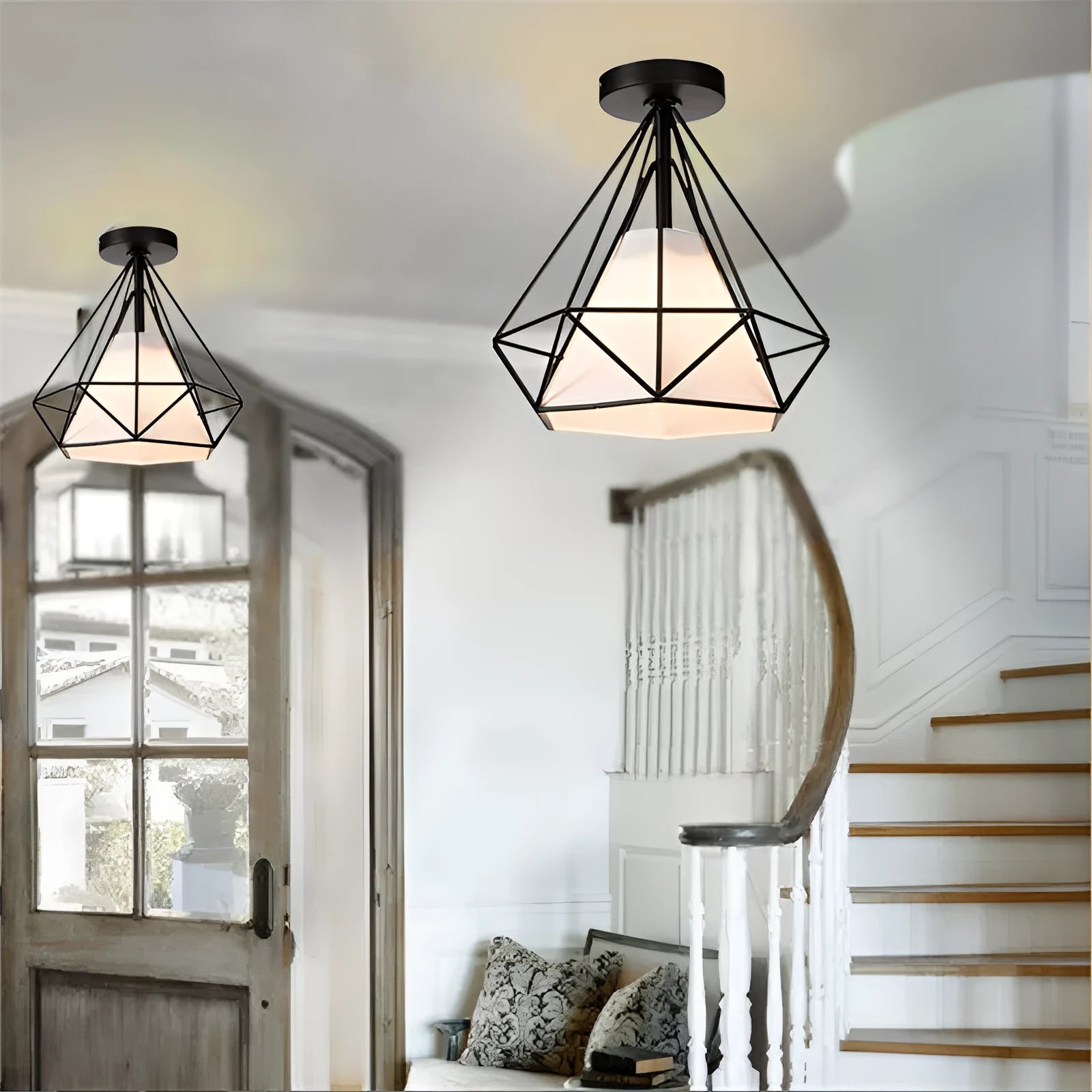Black ceiling lamp with 10cm diameter and 1 metre adjustable drop against a white ceiling