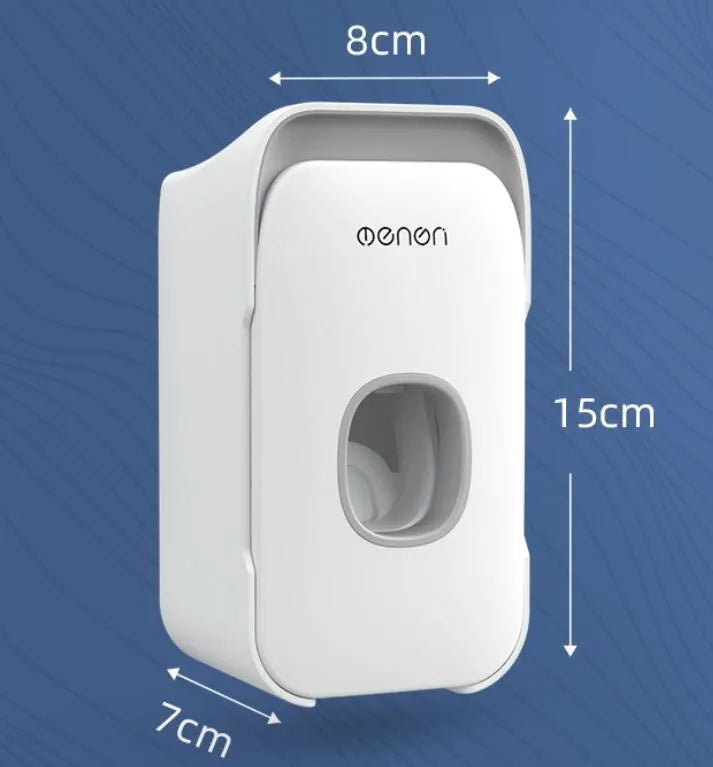 Blue automatic toothpaste dispenser mounted on a bathroom wall with a transparent window showing paste inside.