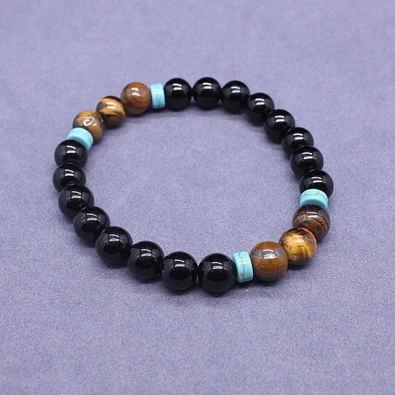 Black agate geometric bead bracelet and matching tiger-shaped tigereye stone necklace set on a grey background.