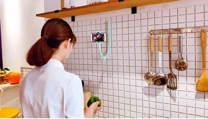 Black flexible rubber phone holder with suction cup base bent into an L-shape