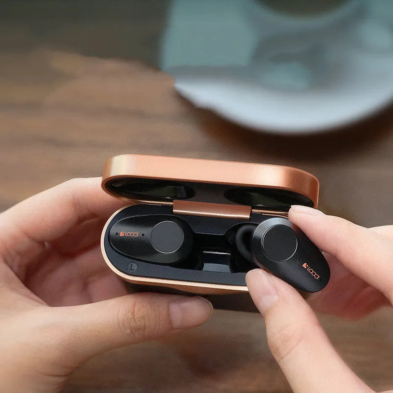 Black wireless Bluetooth headset with charging stand showing type-C port and wireless charging surface
