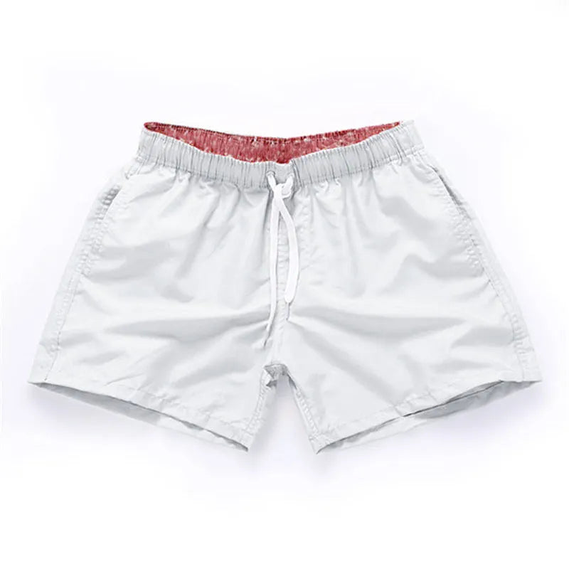 Men's black polyester beach shorts with a straight leg, shown on a size chart with options up to 4XL.