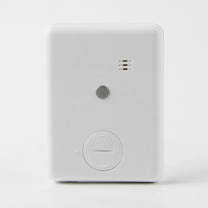 Black and white digital kitchen timer with magnetic back and display showing countdown time.