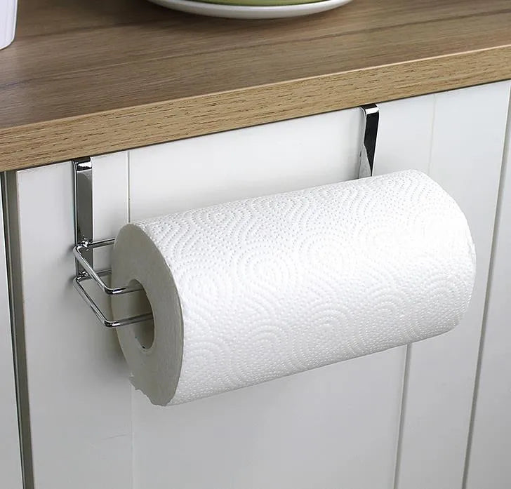 Silver stainless steel paper towel rack hanging on a cabinet door.