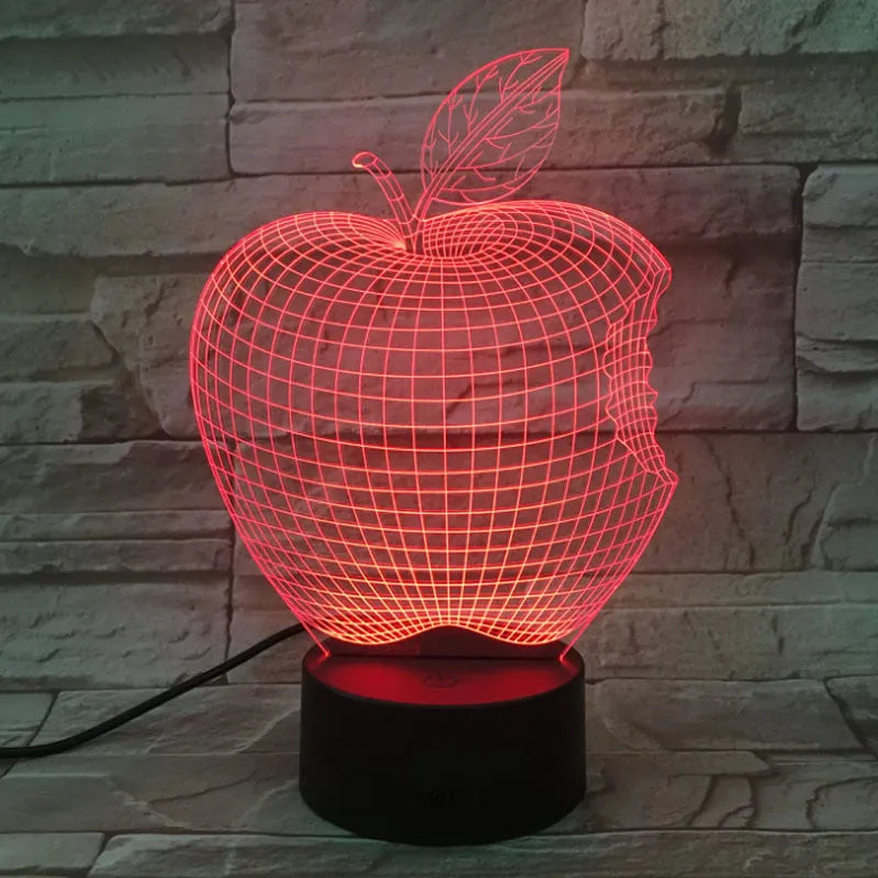 3D fruit-shaped colourful LED night light with touch control on a table.