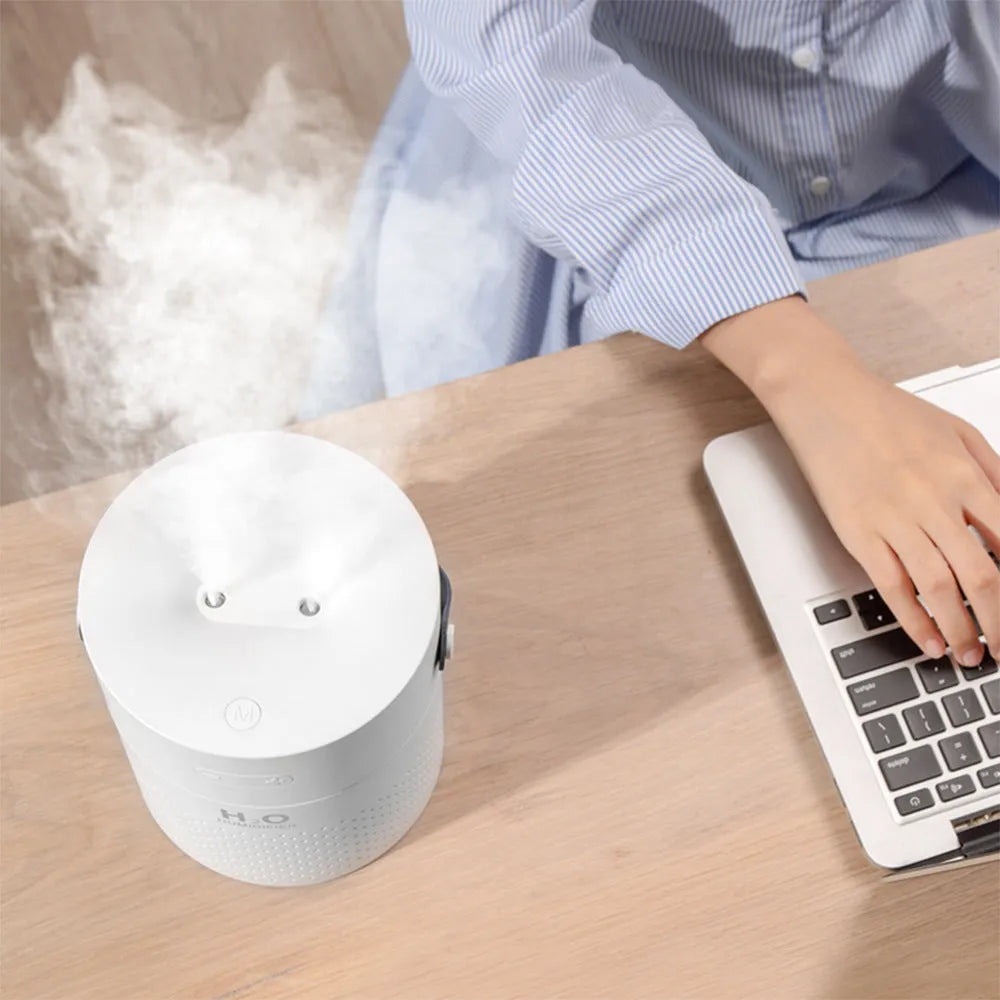 Slim modern USB rechargeable humidifier with coloured lights on a bedroom side table.