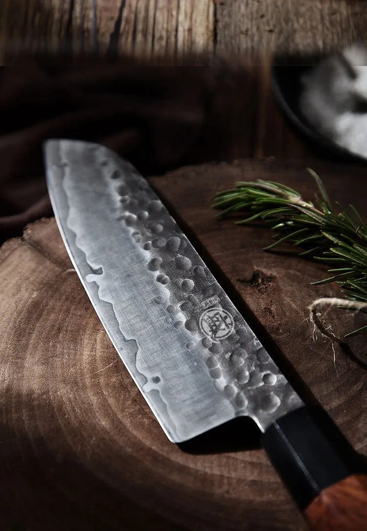 Silver hand forged Santoku chef knife with 4034ZW stainless steel blade, 149cm length, on cutting board