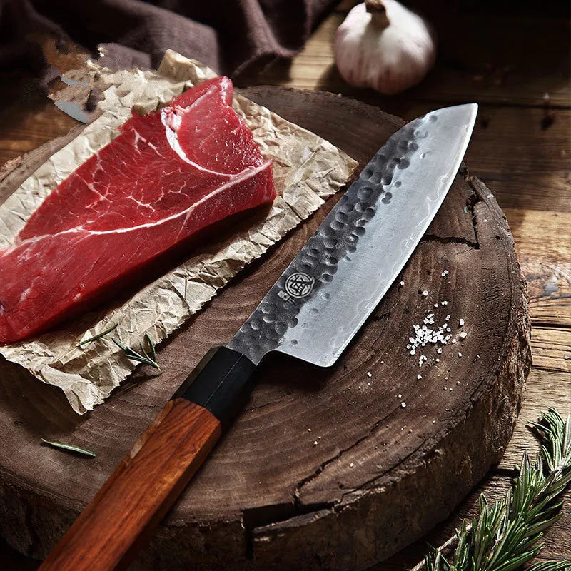 Silver hand forged Santoku chef knife with 4034ZW stainless steel blade, 149cm length, on cutting board