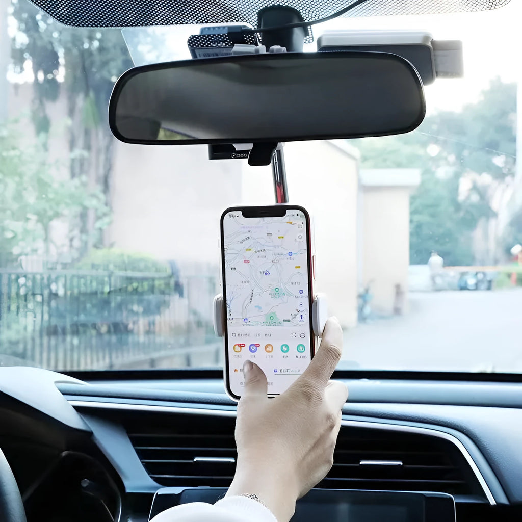 Black mobile phone bracket mounted on car rearview mirror holding smartphone